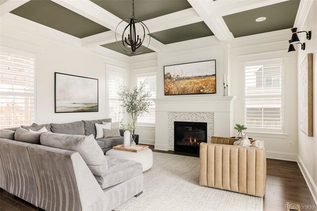 living room with baseboards, wood finished floors, a tile fireplace, beamed ceiling, and coffered ceiling
