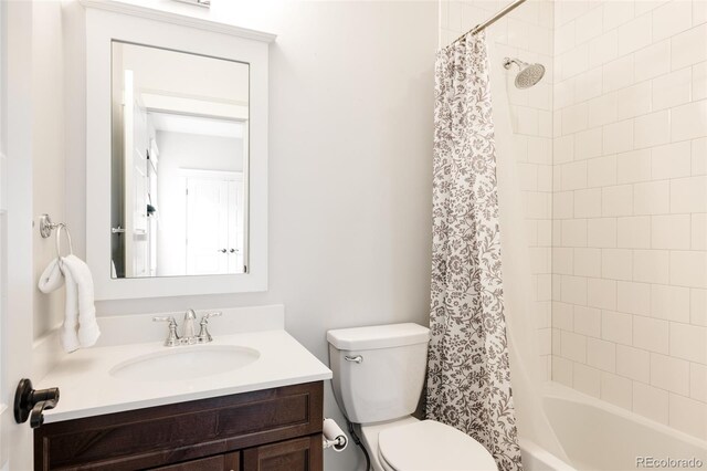 full bath featuring vanity, shower / bathtub combination with curtain, and toilet