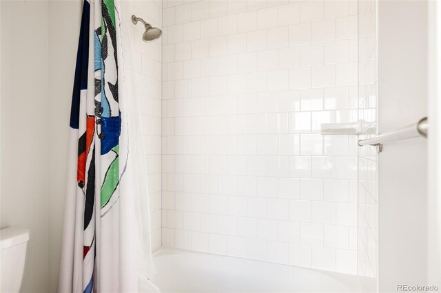 bathroom with toilet and shower / tub combo