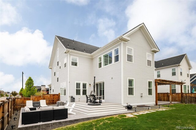 back of house featuring a yard, a patio, an outdoor living space, and a fenced backyard