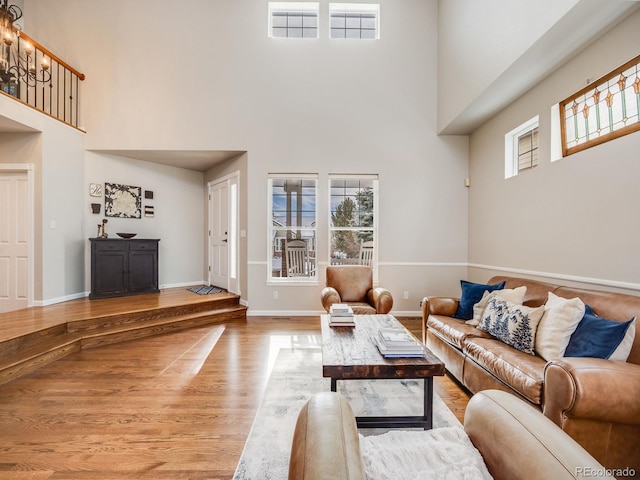 living room with hardwood / wood-style flooring and a high ceiling