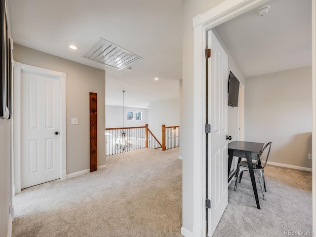 hallway with light colored carpet