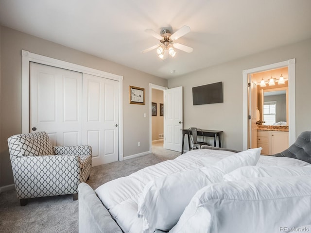 bedroom featuring ceiling fan, ensuite bathroom, carpet flooring, and a closet