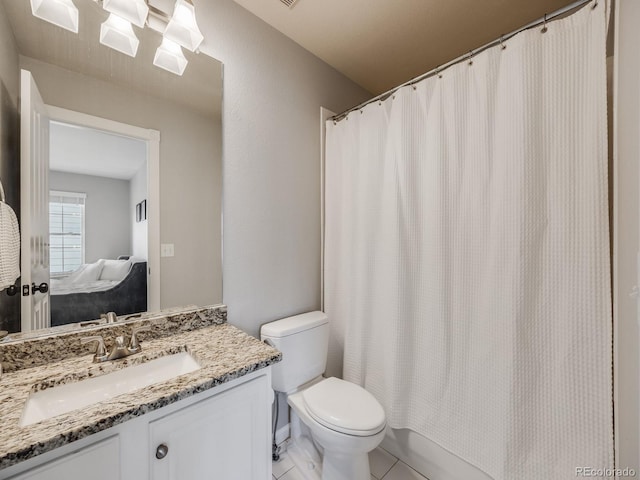 bathroom with vanity, tile patterned flooring, and toilet