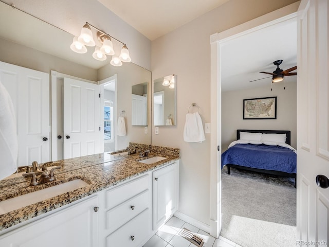 bathroom featuring tile patterned flooring, vanity, and ceiling fan with notable chandelier