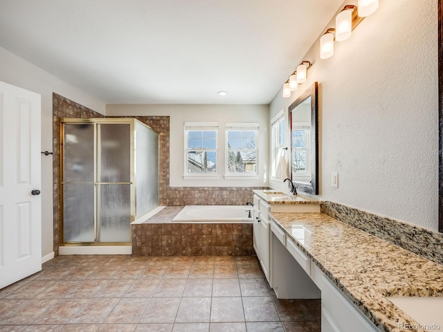 bathroom featuring vanity and independent shower and bath