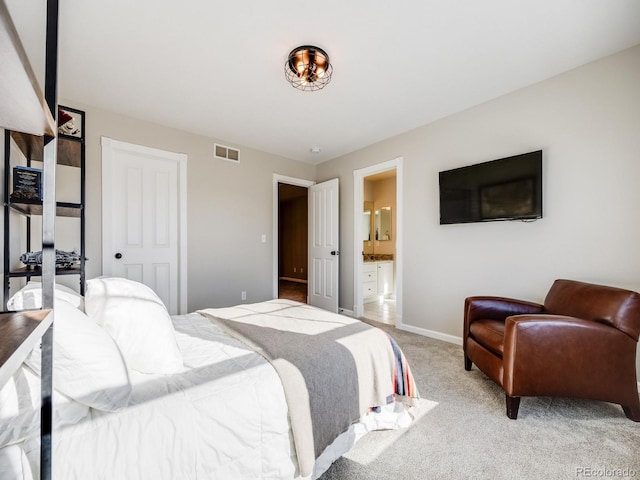 carpeted bedroom featuring a closet and ensuite bathroom