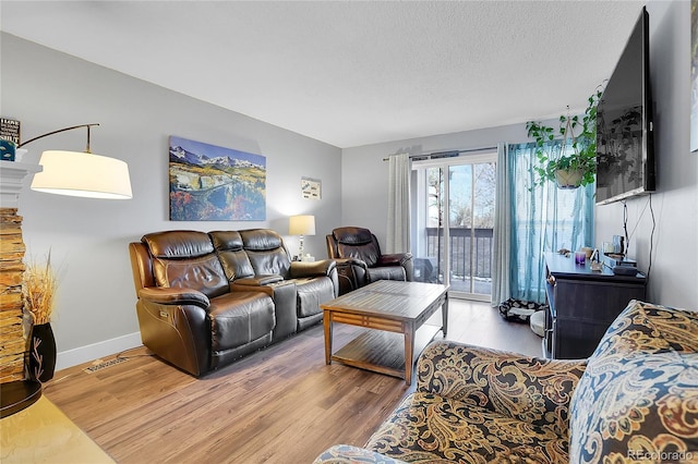 living room featuring a textured ceiling and hardwood / wood-style flooring