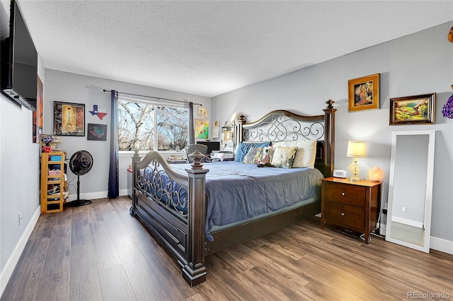 bedroom featuring a textured ceiling and hardwood / wood-style flooring