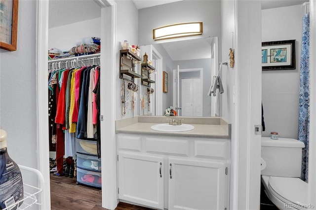 bathroom featuring hardwood / wood-style floors, vanity, a textured ceiling, and toilet