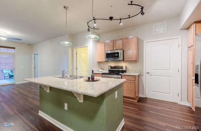 13456 Via Varra Unit 114, Broomfield, CO 80020 - kitchen featuring a sink, an island with sink, stainless steel appliances, visible vents, and dark wood-style floors