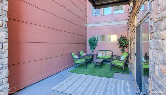13456 Via Varra Unit 114, Broomfield, CO 80020 - view of patio with an outdoor hangout area