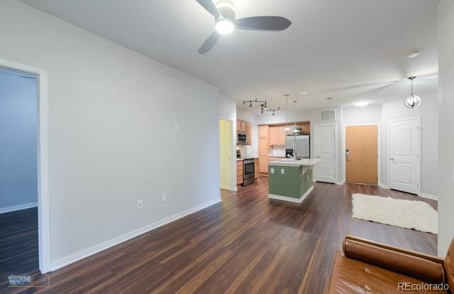 13456 Via Varra Unit 114, Broomfield, CO 80020 - living room featuring a ceiling fan, baseboards, dark wood finished floors, and visible vents