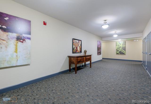 13456 Via Varra Unit 114, Broomfield, CO 80020 - empty room featuring carpet floors and baseboards