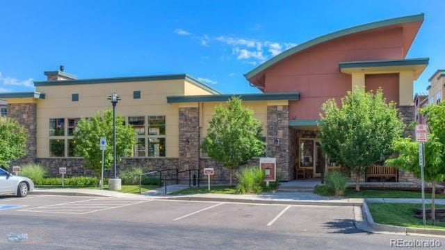13456 Via Varra Unit 114, Broomfield, CO 80020 - view of building exterior with uncovered parking