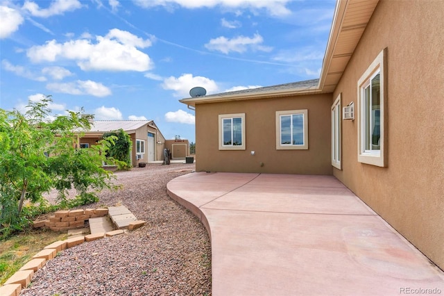 491 Newlin Ridge Rd, Florence, CO 81226 - back of property featuring stucco siding, a patio, and a wall mounted AC