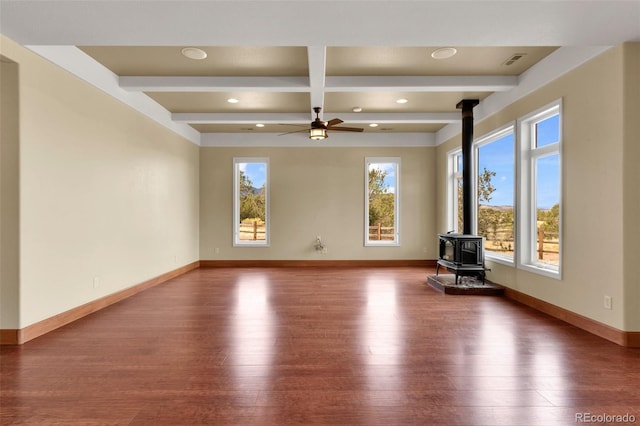 491 Newlin Ridge Rd, Florence, CO 81226 - unfurnished living room featuring a wood stove, wood finished floors, beam ceiling, a ceiling fan, and recessed lighting