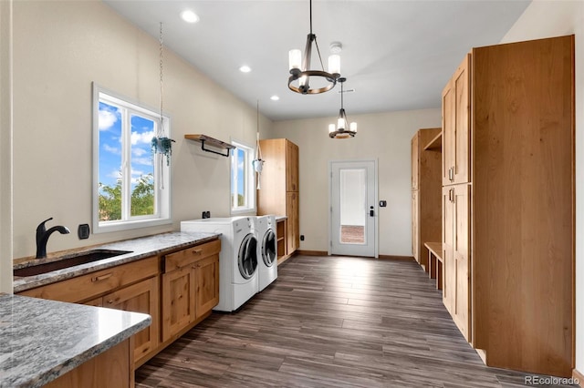 491 Newlin Ridge Rd, Florence, CO 81226 - laundry area featuring washing machine and dryer, a chandelier, dark wood-style flooring, recessed lighting, and cabinet space