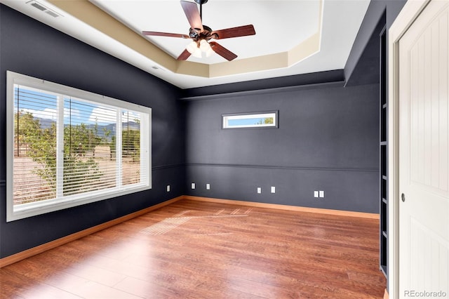 491 Newlin Ridge Rd, Florence, CO 81226 - spare room with wood finished floors, plenty of natural light, a raised ceiling, and a ceiling fan