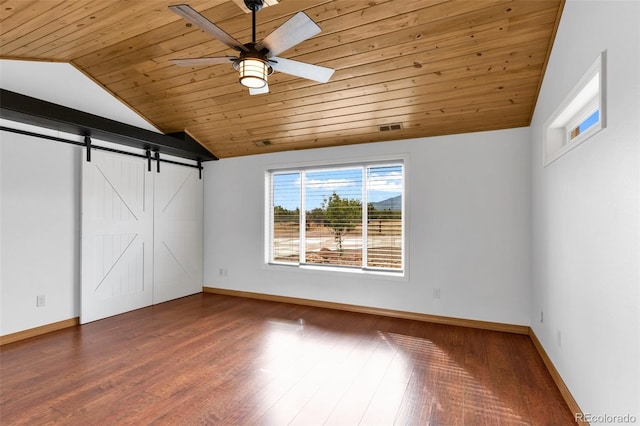 491 Newlin Ridge Rd, Florence, CO 81226 - unfurnished bedroom with wood ceiling, vaulted ceiling, baseboards, wood finished floors, and a barn door