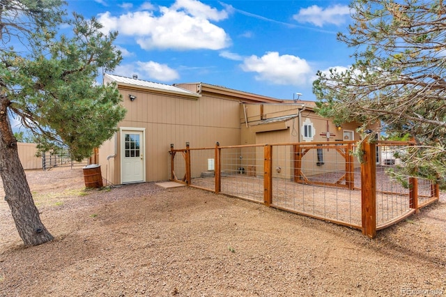491 Newlin Ridge Rd, Florence, CO 81226 - rear view of house featuring a gate, fence, and metal roof