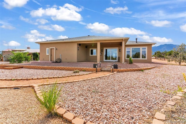 491 Newlin Ridge Rd, Florence, CO 81226 - rear view of house featuring stucco siding, a patio, and a mountain view