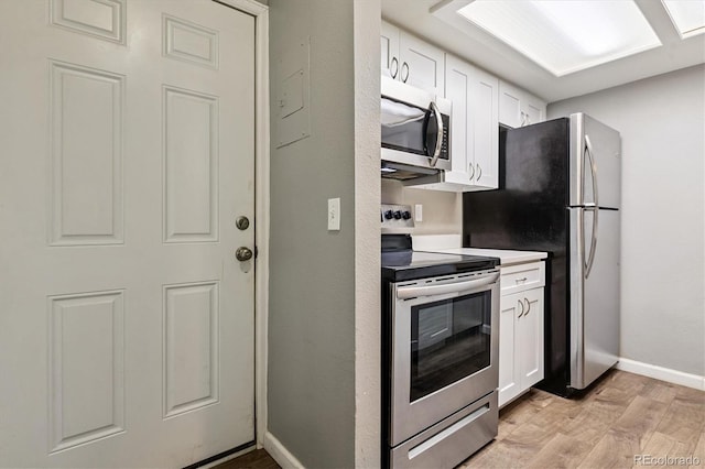 447 S Memphis Way Unit 7, Aurora, CO 80017 - kitchen with stainless steel appliances, light wood-style flooring, and white cabinetry