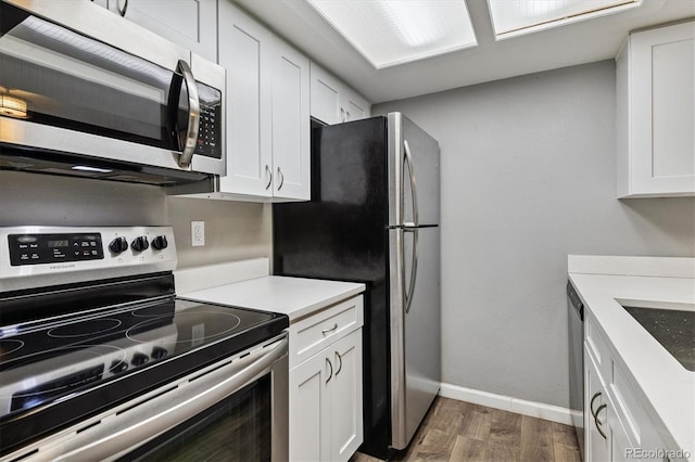 447 S Memphis Way Unit 7, Aurora, CO 80017 - kitchen featuring stainless steel appliances, wood finished floors, white cabinets, and light countertops
