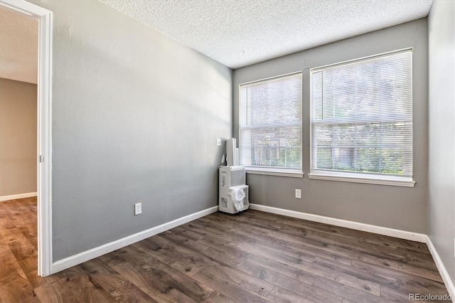 447 S Memphis Way Unit 7, Aurora, CO 80017 - spare room featuring wood finished floors and a textured ceiling