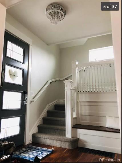 4428 Perry St, Denver, CO 80212 - foyer with stairway, wood finished floors, and a chandelier