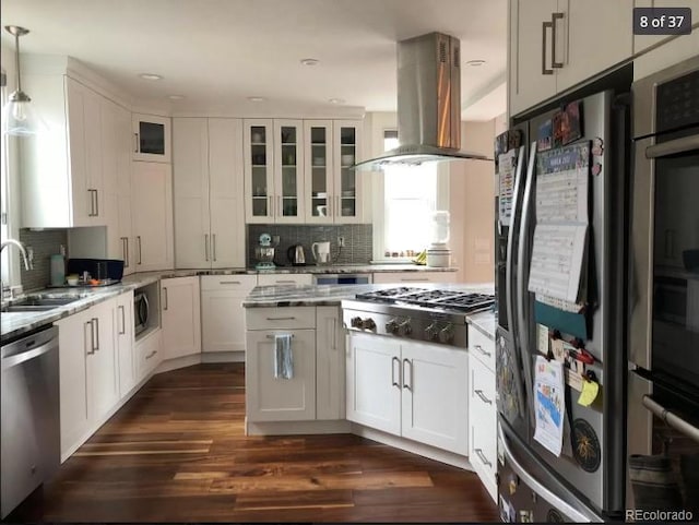4428 Perry St, Denver, CO 80212 - kitchen with stainless steel appliances, island exhaust hood, backsplash, white cabinets, and recessed lighting