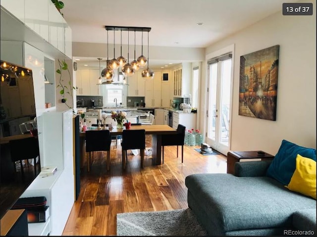 4428 Perry St, Denver, CO 80212 - living room featuring wood finished floors and a chandelier