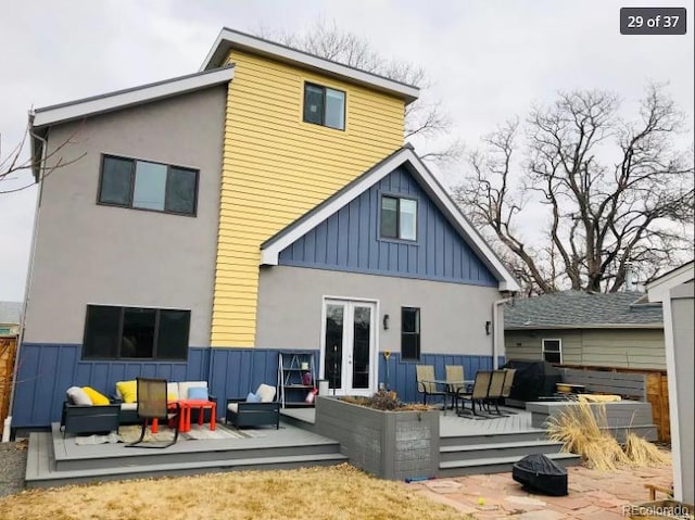 4428 Perry St, Denver, CO 80212 - rear view of house with a wooden deck, board and batten siding, french doors, and an outdoor living space with a fire pit