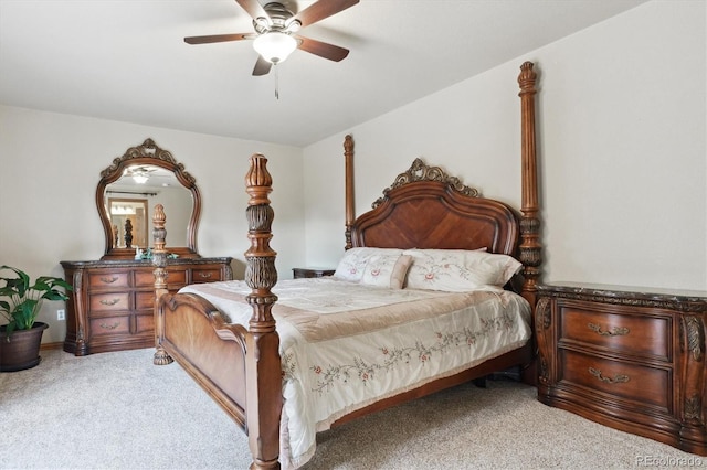 bedroom featuring light colored carpet and a ceiling fan