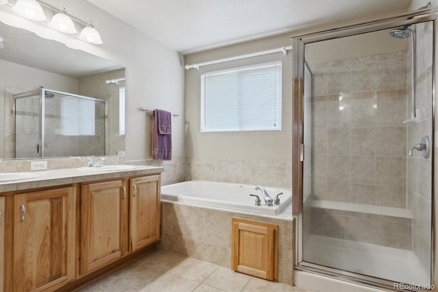 bathroom featuring a garden tub, a stall shower, a sink, tile patterned flooring, and double vanity