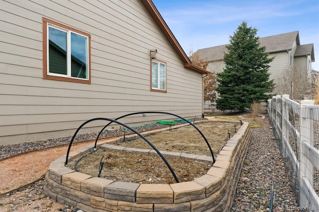 view of side of home with fence