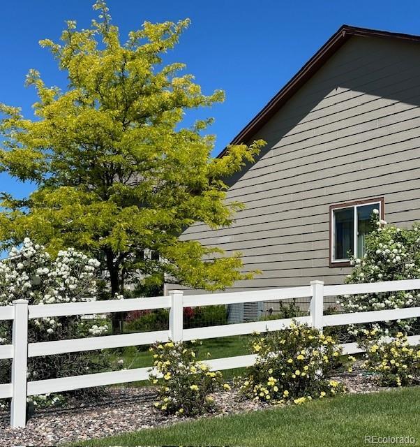 view of side of home featuring fence