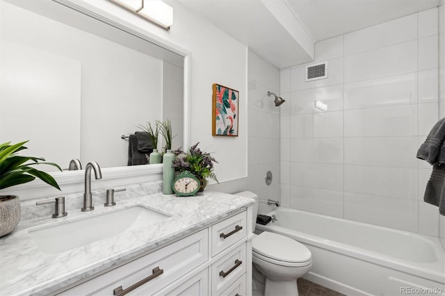 full bathroom featuring toilet, vanity, and tiled shower / bath combo