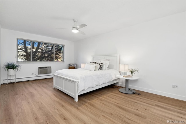 bedroom with baseboard heating, a wall mounted AC, ceiling fan, and light hardwood / wood-style floors