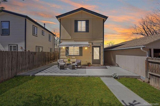 1343 Valentia St, Denver, CO 80220 - back of property at dusk featuring an outdoor hangout area and a patio area