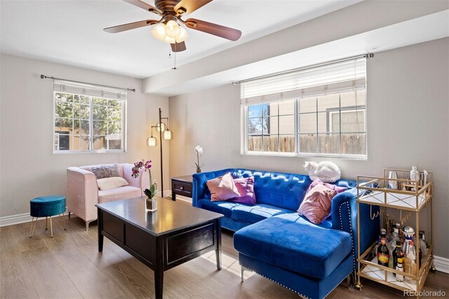 1343 Valentia St, Denver, CO 80220 - living room with wood finished floors, a ceiling fan, and baseboards