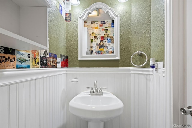 1343 Valentia St, Denver, CO 80220 - bathroom featuring wainscoting, a sink, and a textured wall