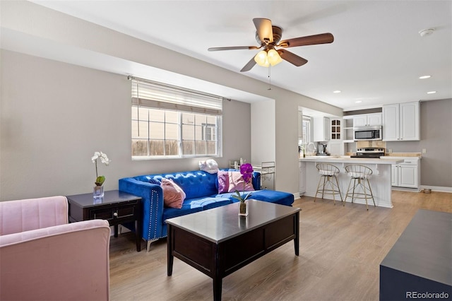 1343 Valentia St, Denver, CO 80220 - living area with a ceiling fan, light wood-style floors, recessed lighting, and baseboards