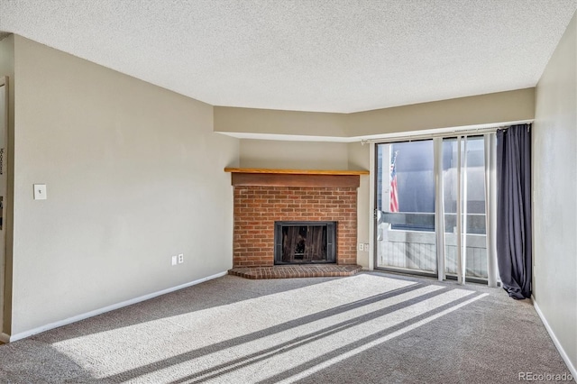 unfurnished living room featuring carpet, a textured ceiling, and a fireplace