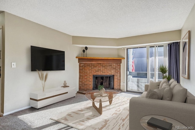 living room featuring a textured ceiling, carpet floors, and a fireplace