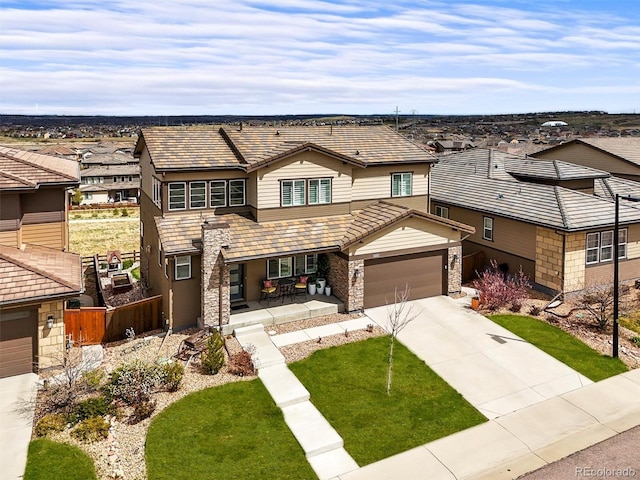 14102 Night Owl Ln, Parker, CO 80134 - view of front of home with driveway, a residential view, stone siding, a porch, and a tile roof