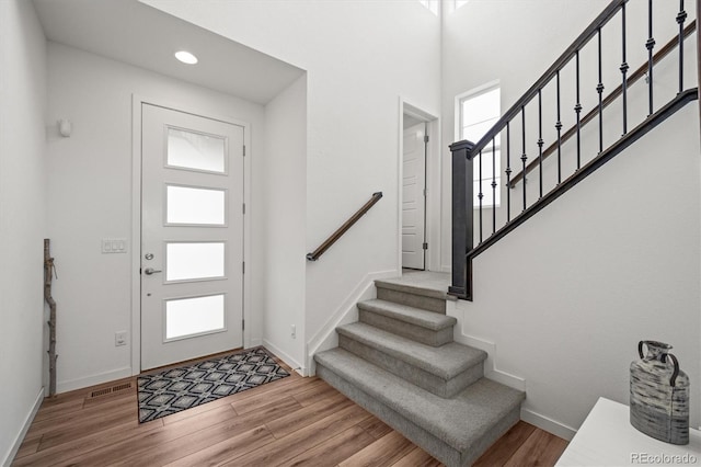 14102 Night Owl Ln, Parker, CO 80134 - foyer with wood finished floors, baseboards, stairs, and recessed lighting