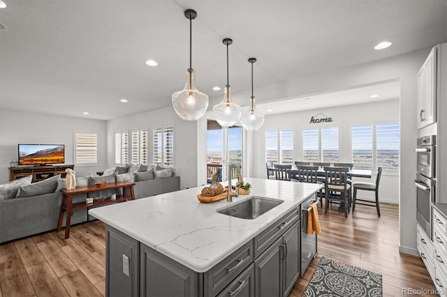 14102 Night Owl Ln, Parker, CO 80134 - kitchen featuring a sink, gray cabinets, stainless steel appliances, open floor plan, and recessed lighting