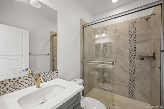 14102 Night Owl Ln, Parker, CO 80134 - full bathroom featuring toilet, vanity, a shower stall, and tasteful backsplash