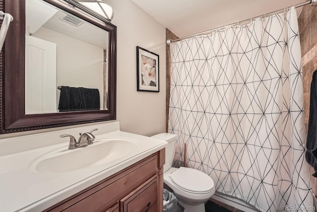 bathroom with vanity, a shower with shower curtain, and toilet